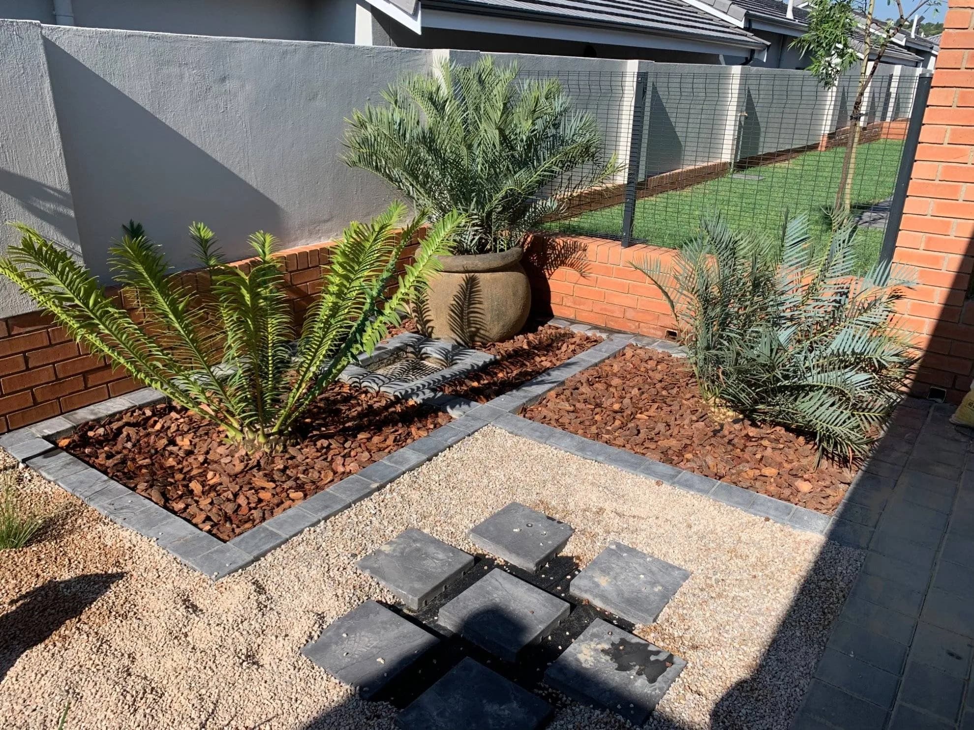 Completed Turfex planting bed with cycads and paved edging in Waterkloof