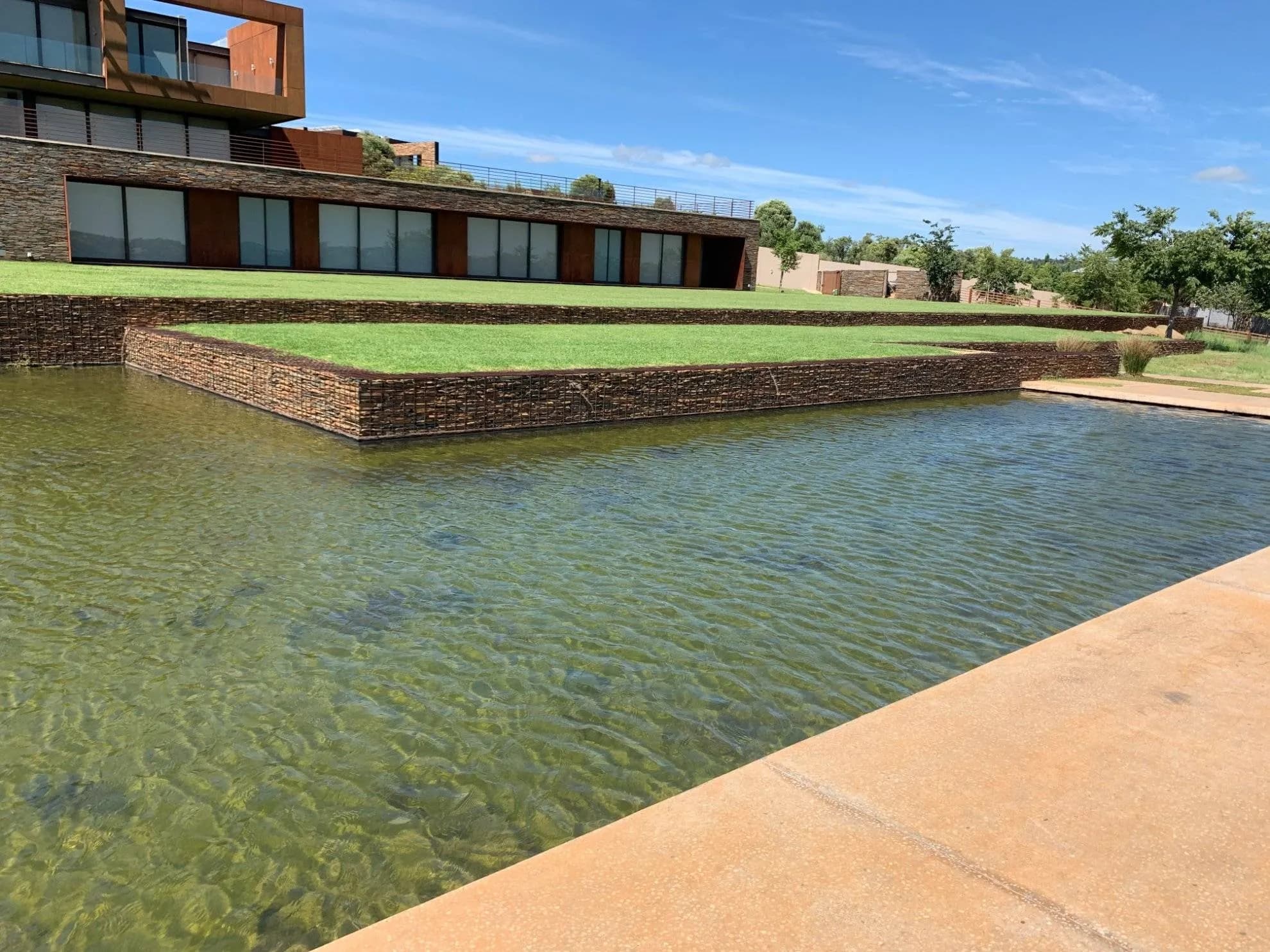 Water channel and gabion walls on a Turfex landscaping project